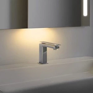 Bathroom faucet with a night light that shines from beneath the mirror.