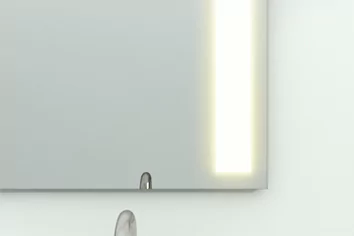  bathroom mirror with a glowing light, illuminating the surroundings.