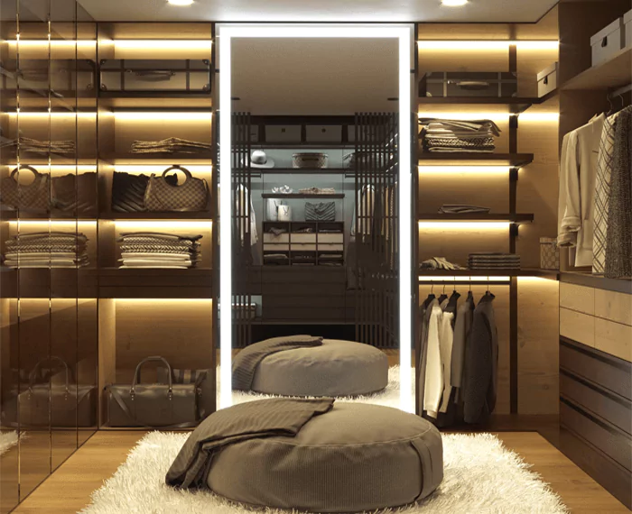 Sophisticated walk-in closet with a luxurious light-framed mirror at the center. 