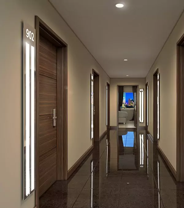 LED light strips beside a wooden door in a fancy and luxurious hotel hallway.