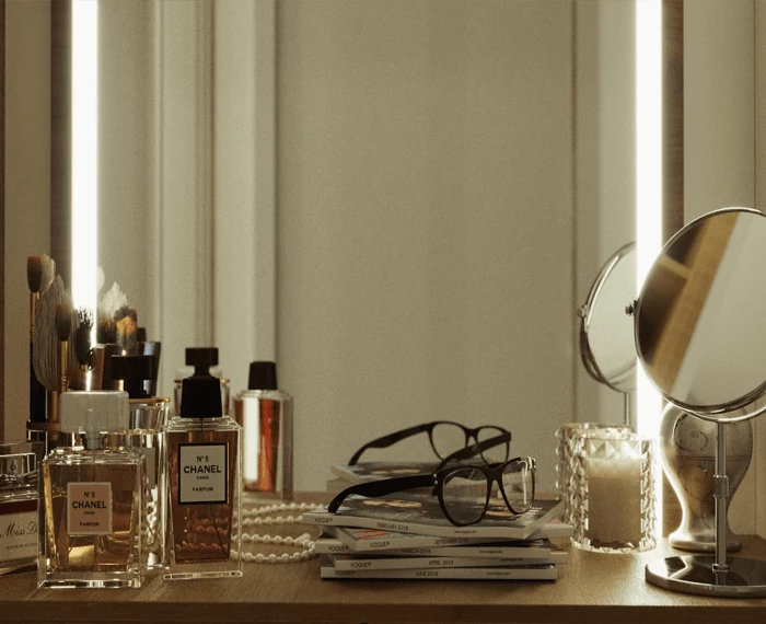 Beauty essentials with reading glass and filed books in front of LED mirror.